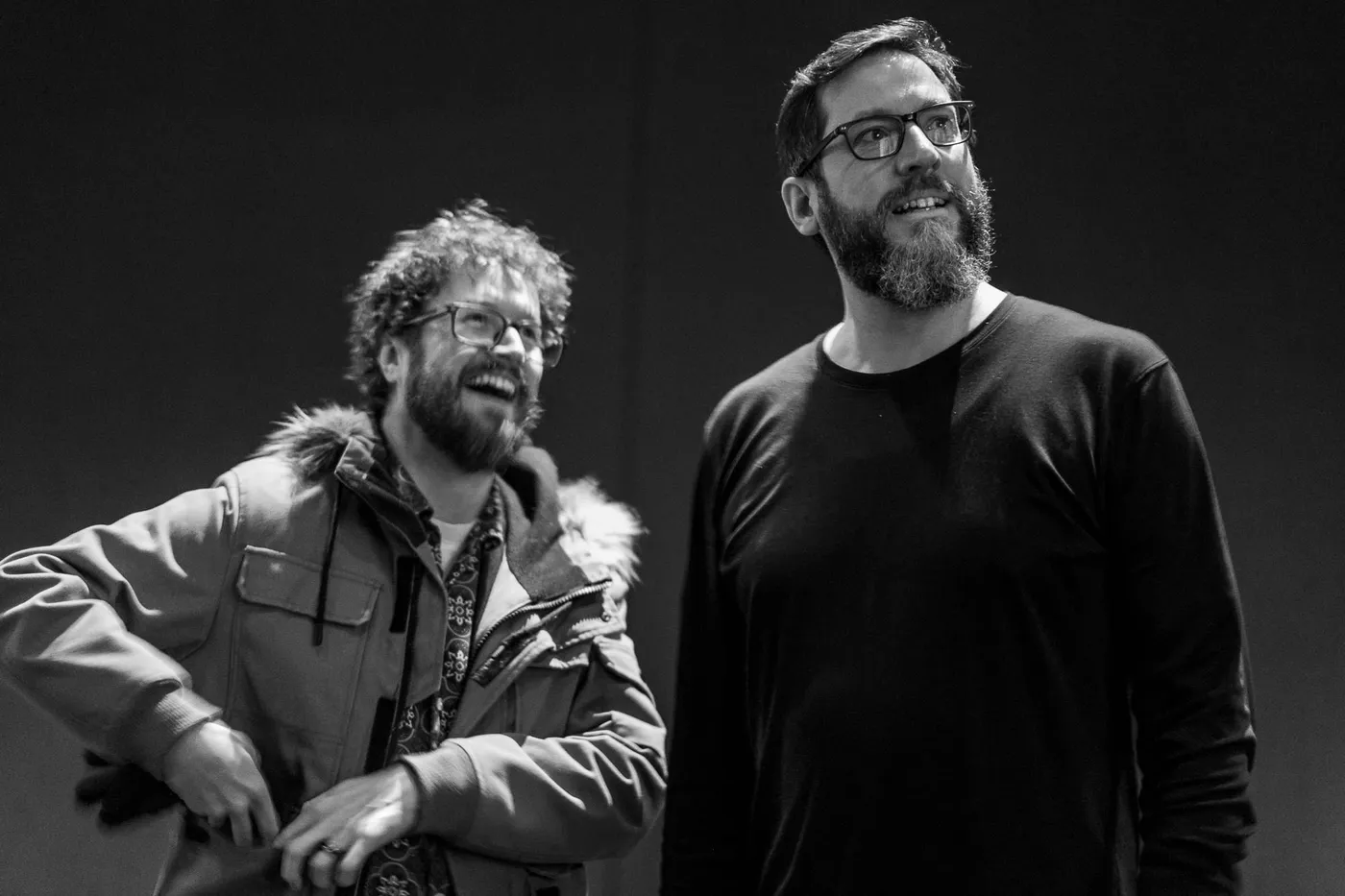 Two people laughing in the foyer
