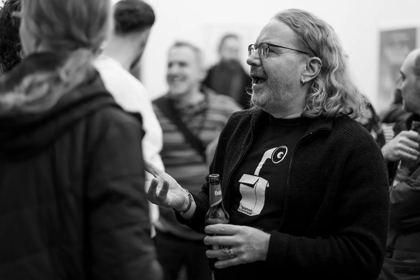 A guest in a conversation in the crowded foyer