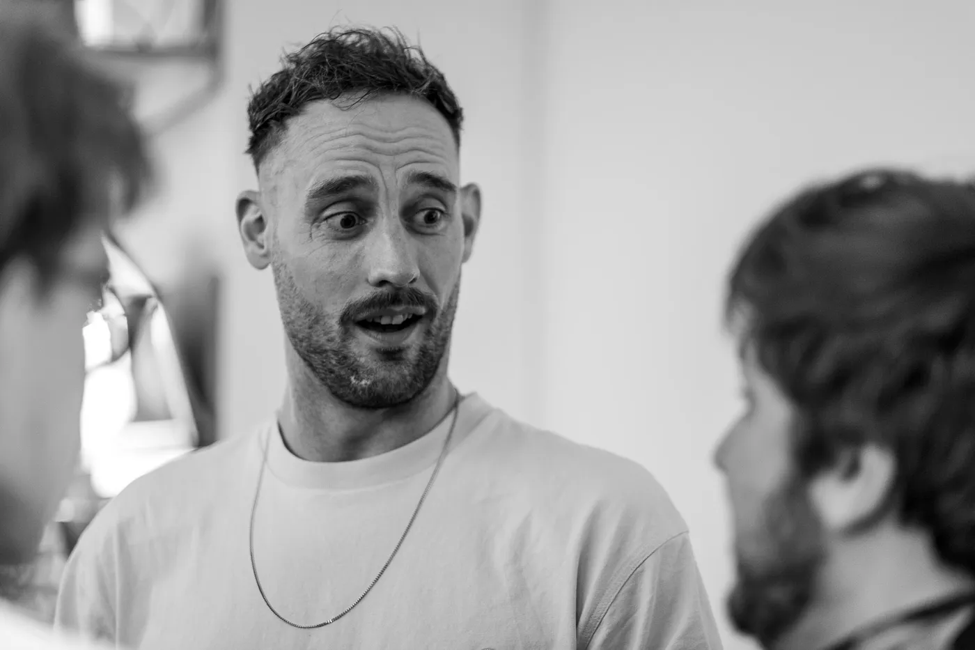 A guest with a surprised expression mid-conversation